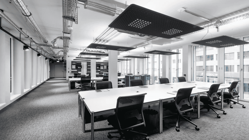 Bright, open-plan office with natural light, comfortable desks, and contemporary design elements.